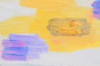 A close up of a painting with yellow and purple colors