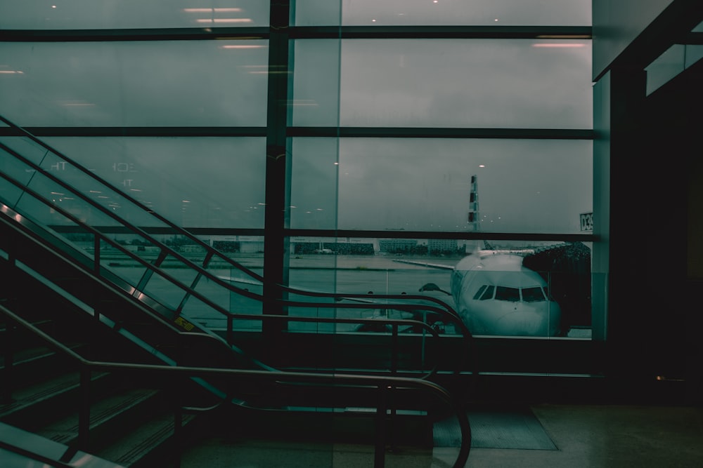 a view of an airplane through a window at an airport