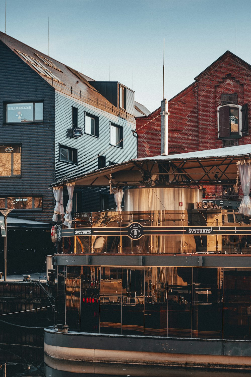 a houseboat is parked in front of some buildings