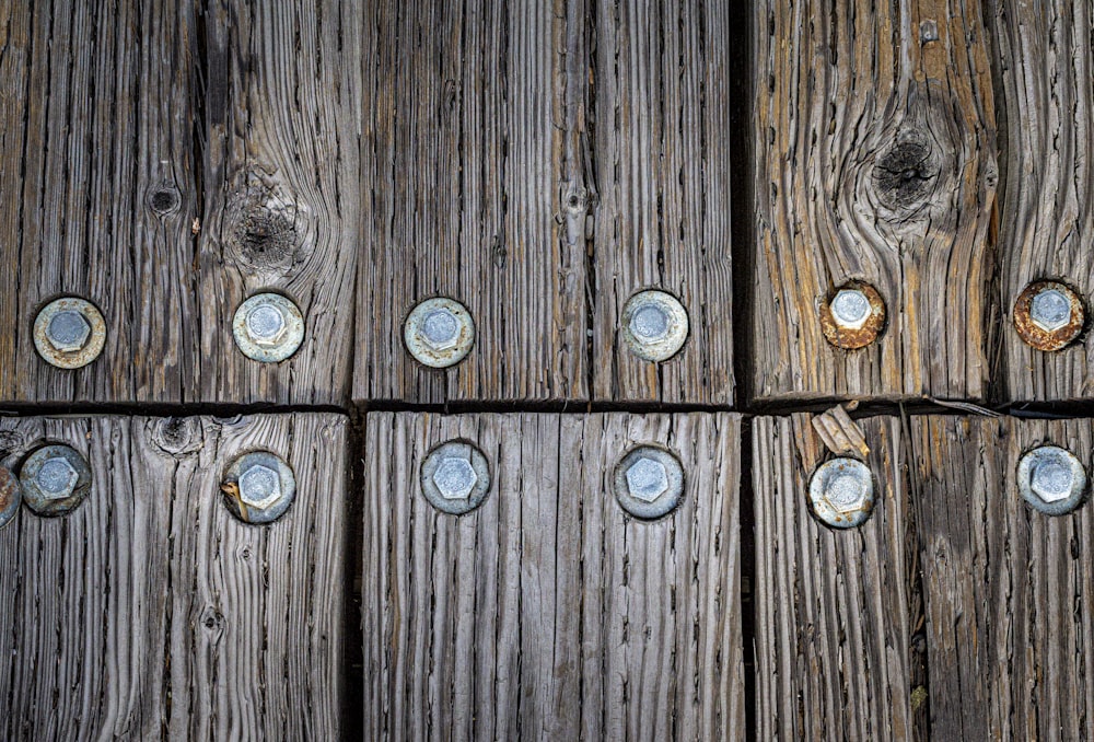 a close up of a wooden fence with screws