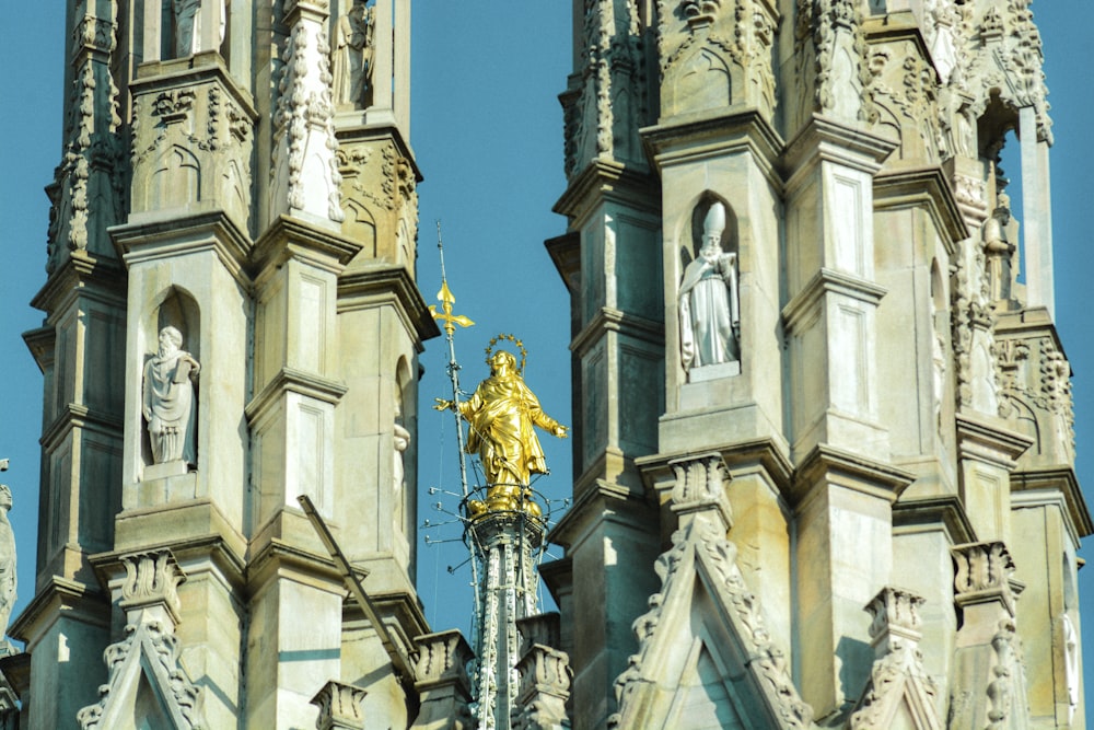 a golden statue on top of a tall building