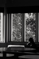 A quiet moment of reflection with a team member reviewing reports by a window.