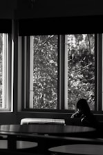 A client working out at home following an online coaching session on a laptop, sunlight streaming in