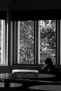 A calm founder smiling while working on a laptop in a cozy, sunlit office.