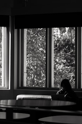 Participants journaling quietly after a session, sunlight streaming through large windows.