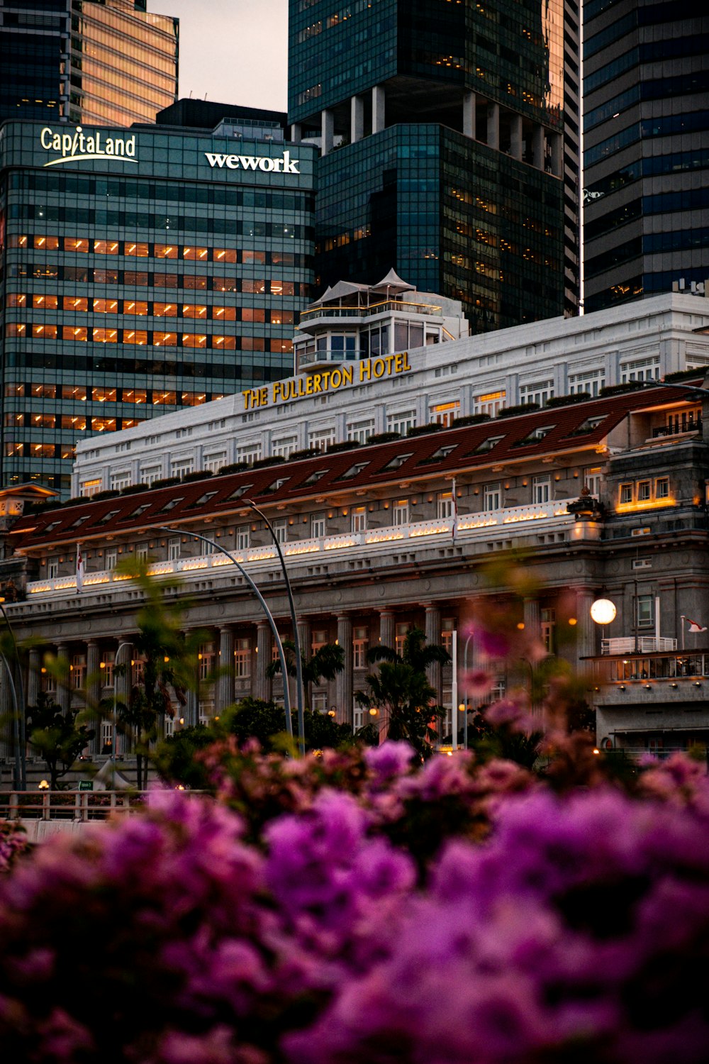 a train station in a city with tall buildings in the background