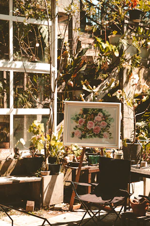A warm, sunlit Moroccan garden with lush plants and gardening tools arranged invitingly.