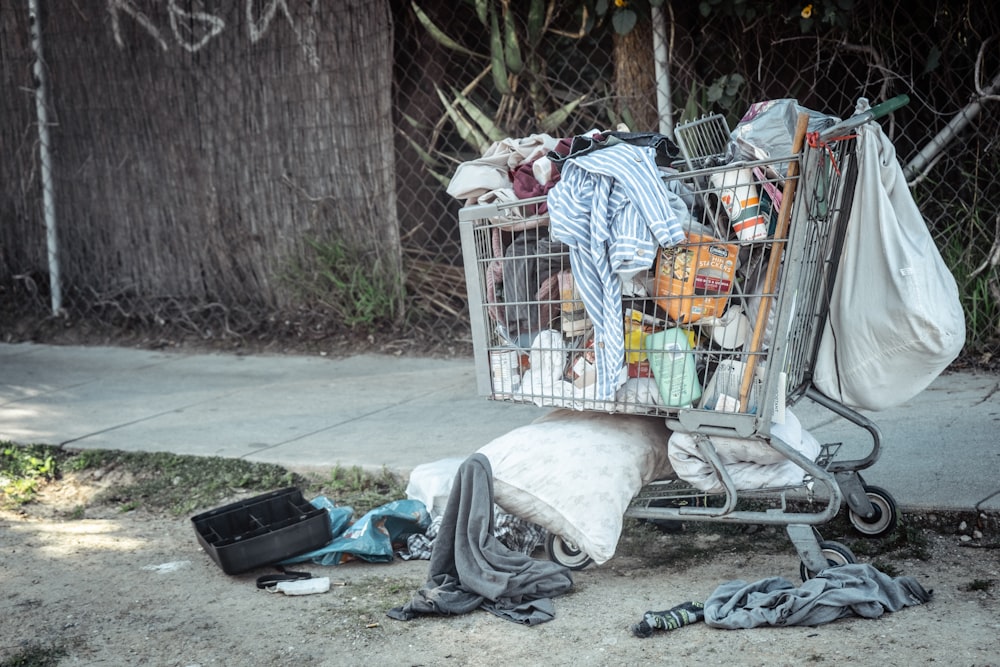 a shopping cart filled with clothes and other items