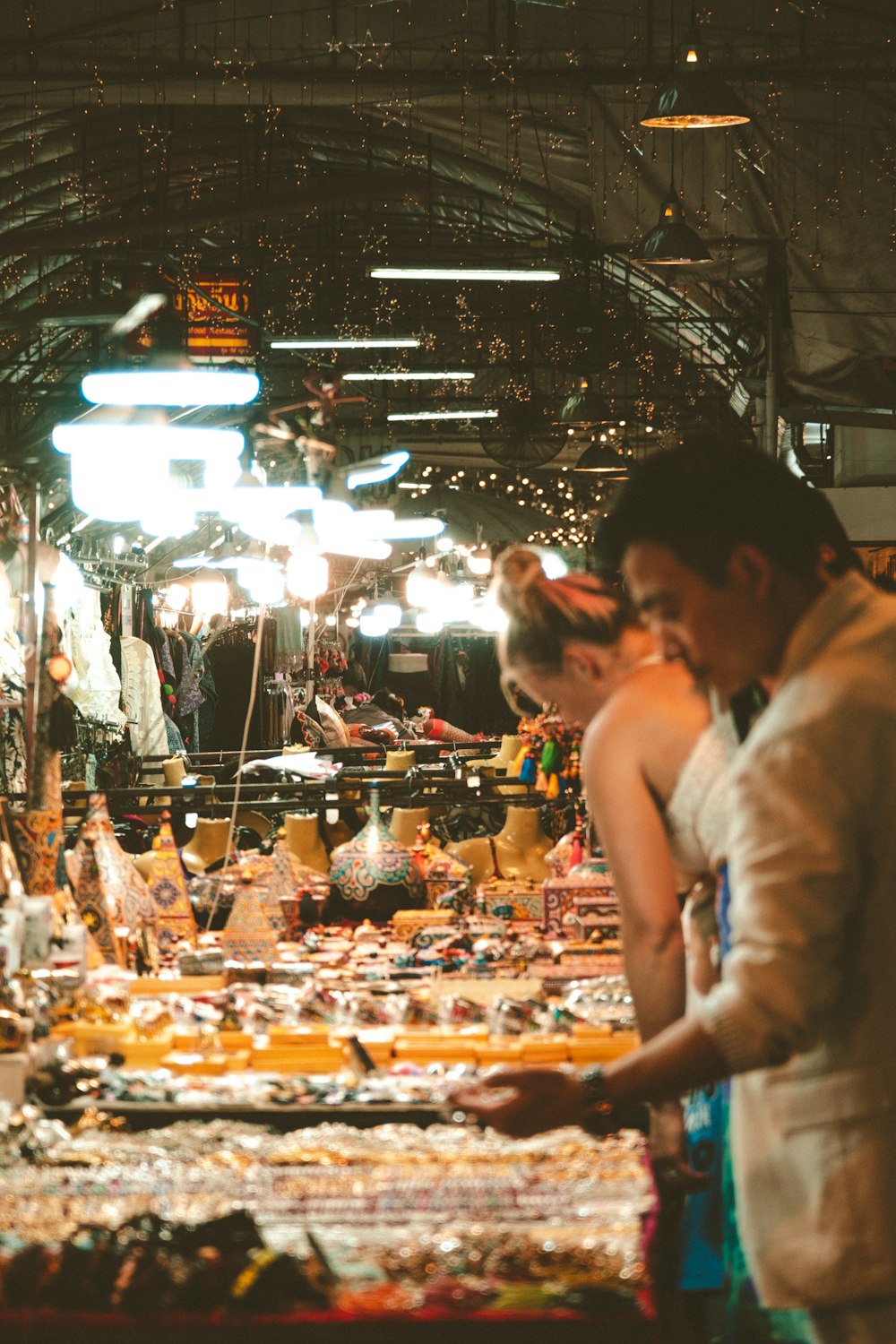 a group of people standing around a market