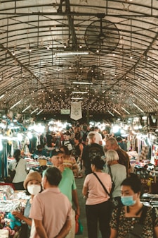 a group of people walking through a market