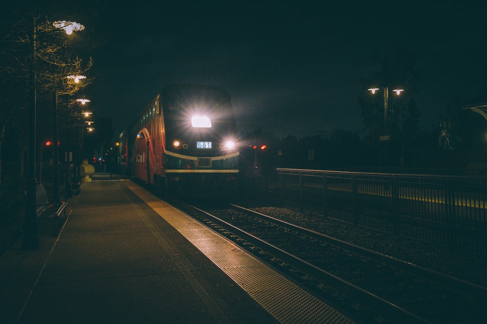 a train traveling down train tracks at night