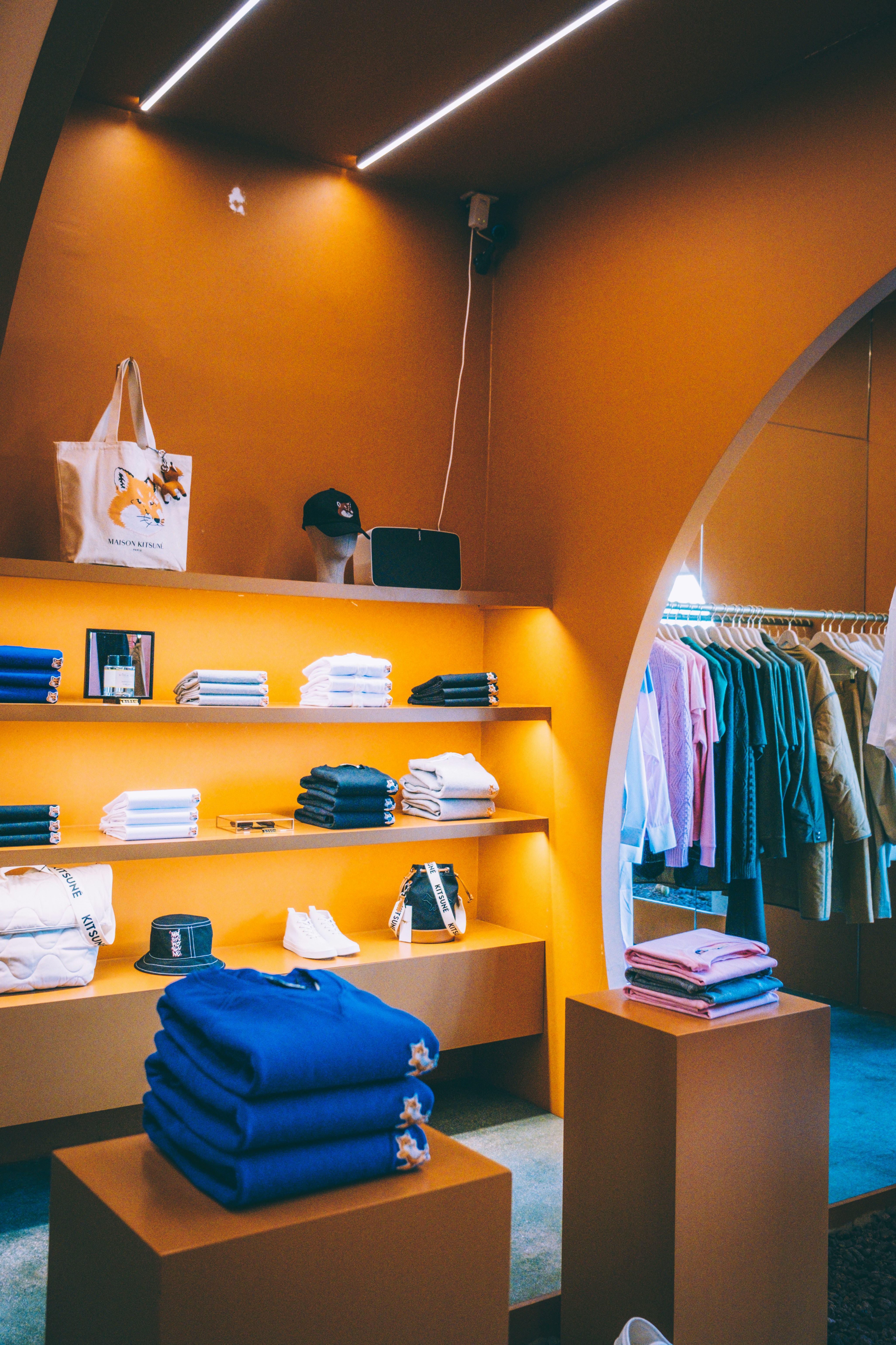 A clothing store with orange walls and shelves photo Free Image on Unsplash