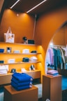 a clothing store with orange walls and shelves