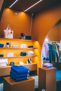 a clothing store with orange walls and shelves