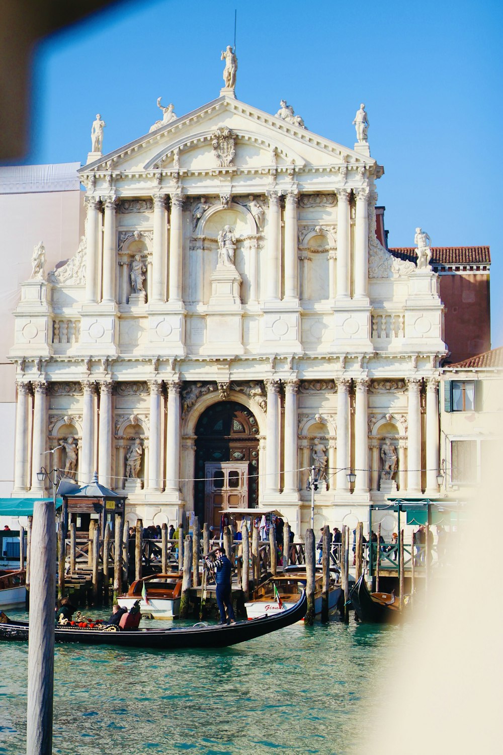 a large white building sitting next to a body of water