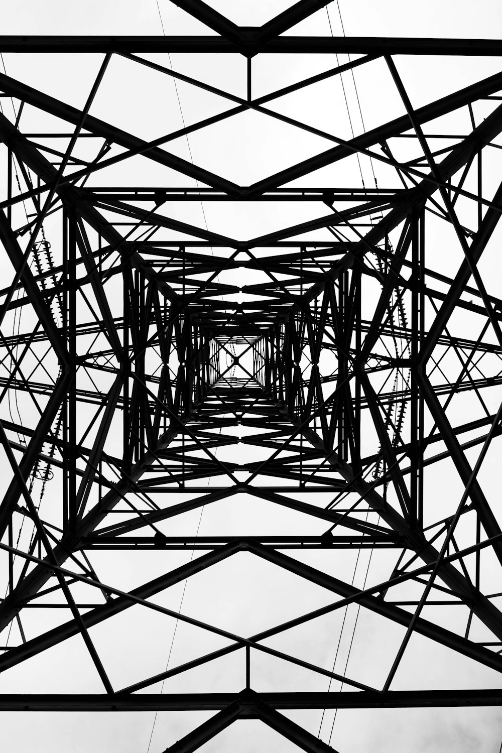 a black and white photo of a high voltage power line