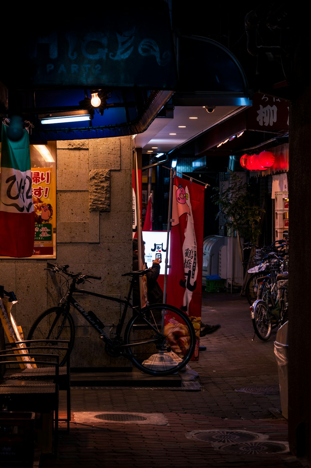 a bike parked in front of a building at night