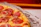 A close-up of a delicious burripizza freshly served in a stylish fast-food setting.