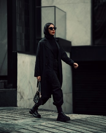 A fashion-forward individual walking confidently in urban surroundings.