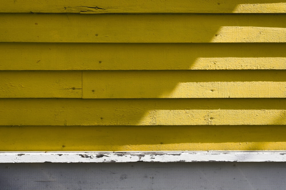 the shadow of a person on a yellow wall