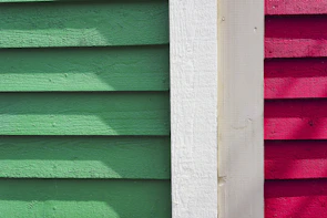 A neat row of new vinyl siding panels on a Queens home, showcasing clean lines and vibrant color.