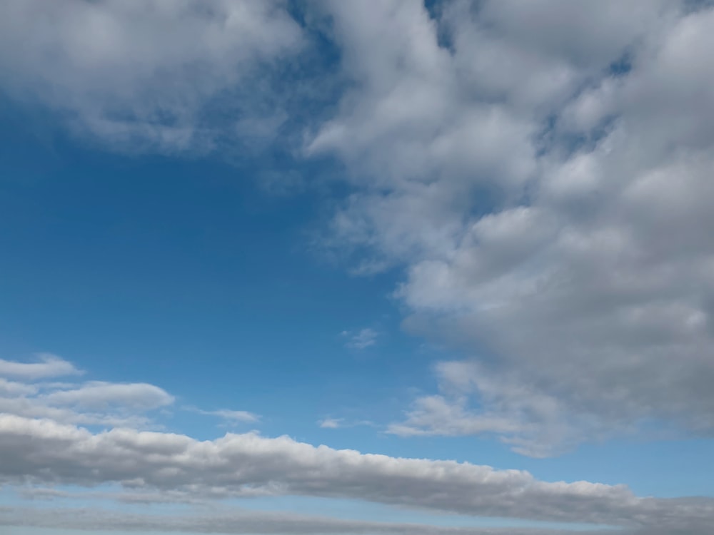 a person standing on a beach flying a kite