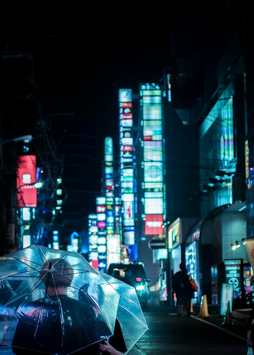 a woman walking down a street holding an umbrella