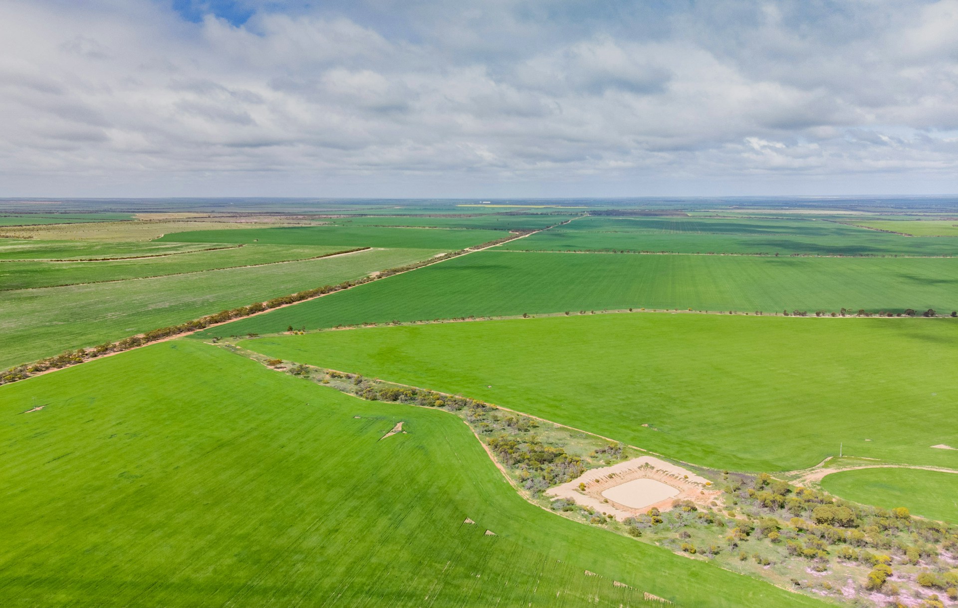 an aerial view of a large green field