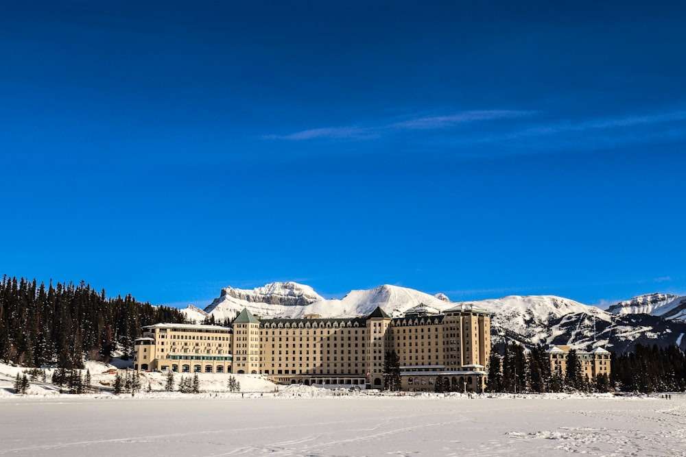 a large building sitting on top of a snow covered field