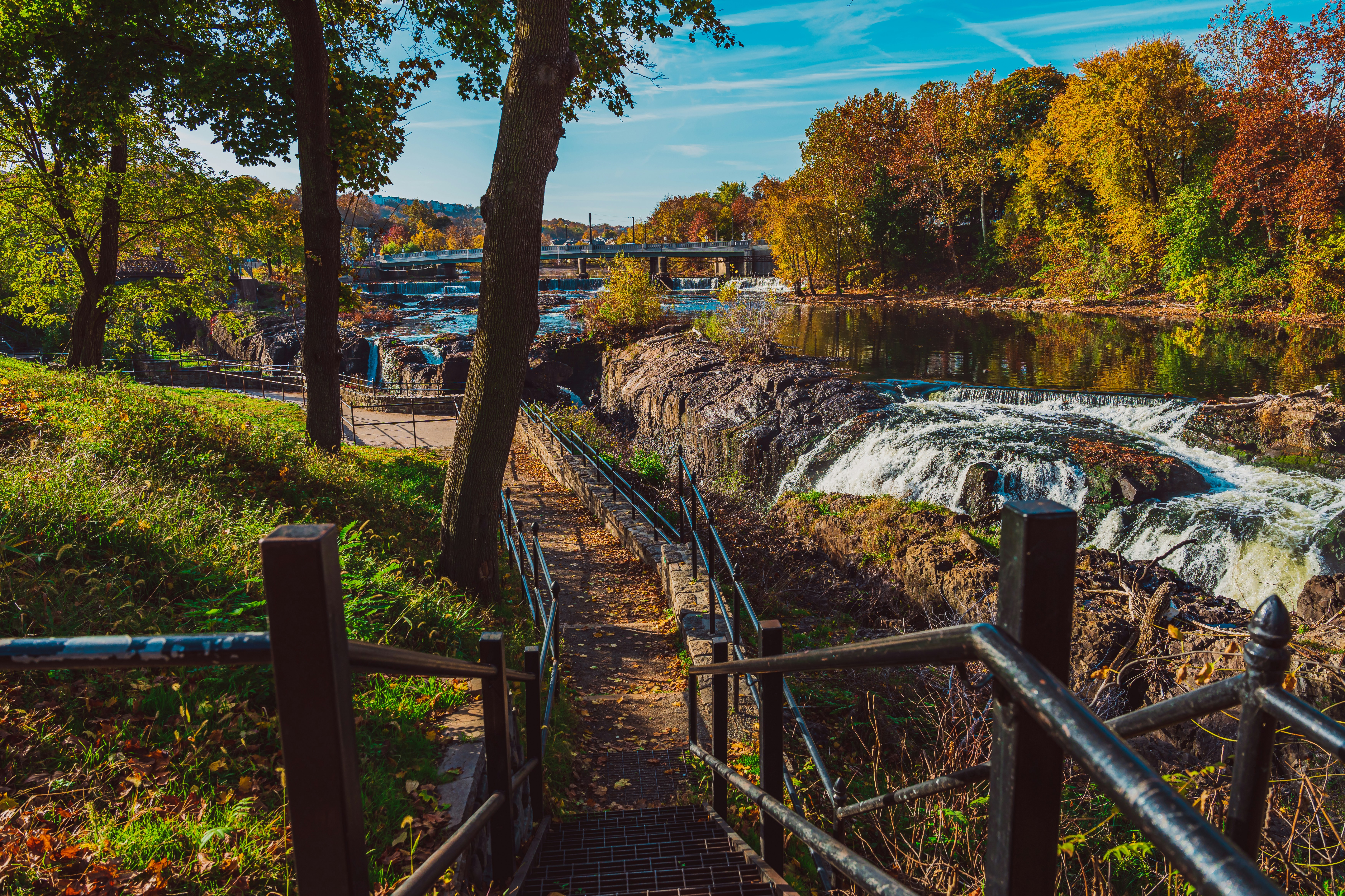 a view of a river with a bridge in the background