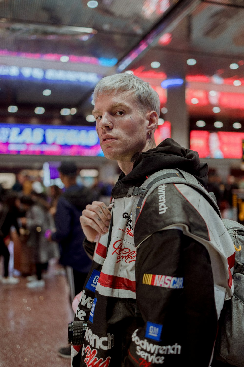 a man in a black and white jacket and a backpack