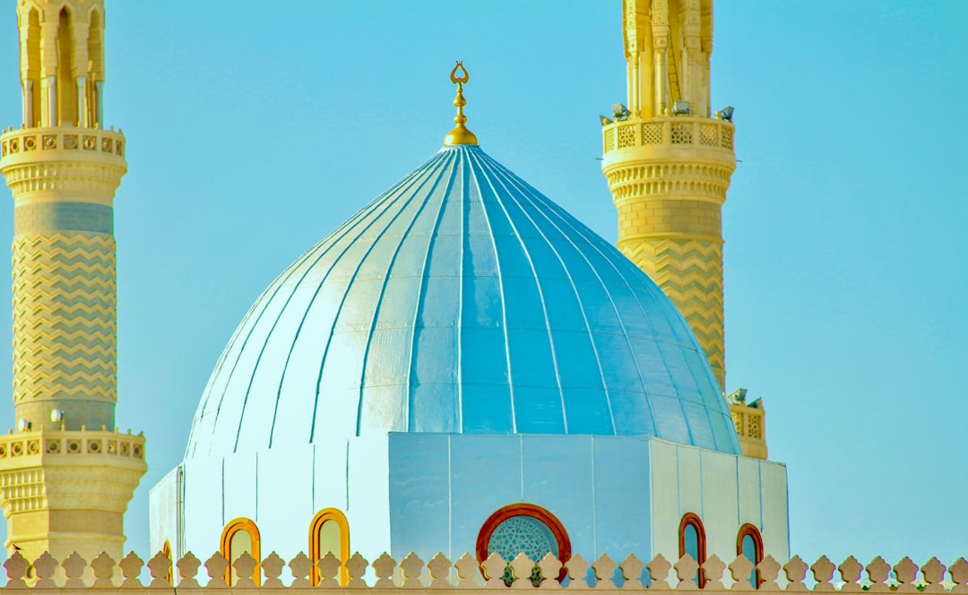 a blue dome on top of a white building,