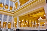 the inside of a large building with chandeliers