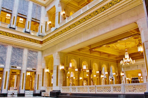 the inside of a large building with chandeliers