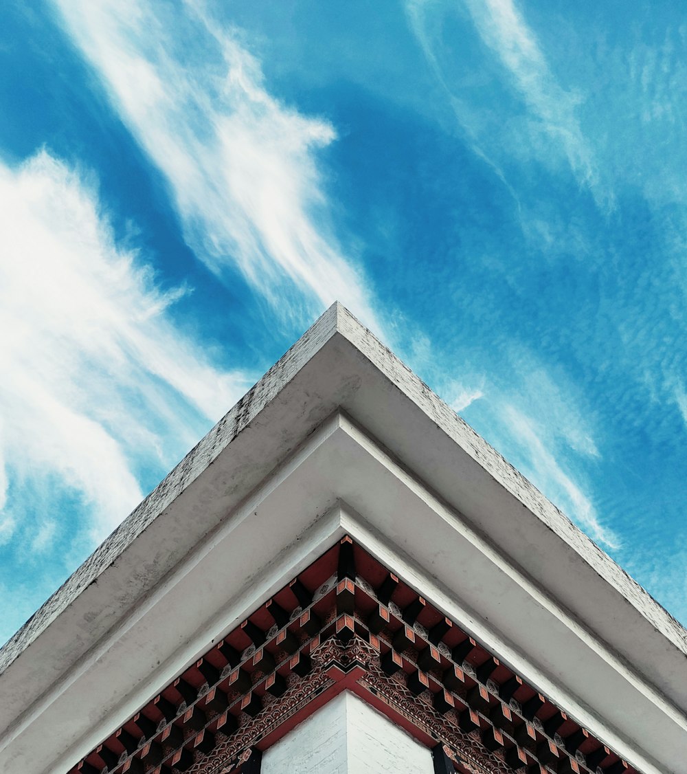 the top of a building with a blue sky in the background