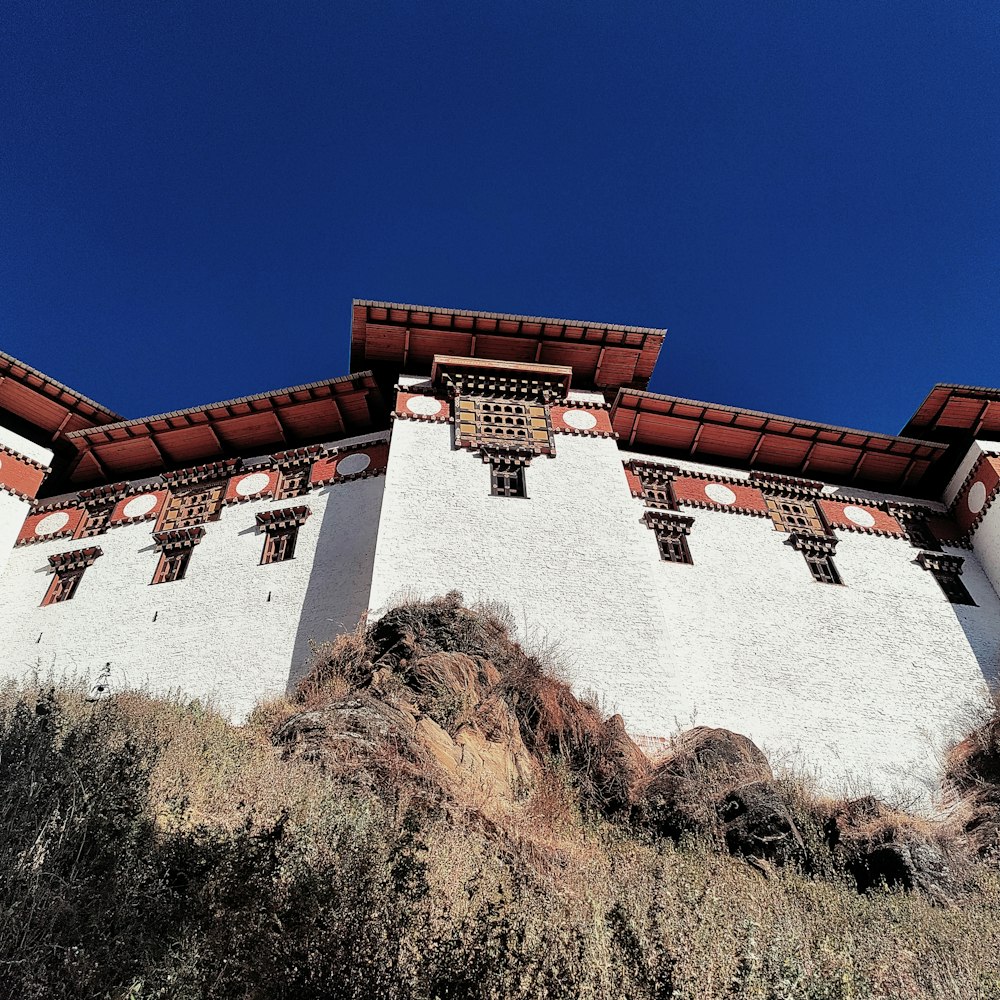 a white and red building with a blue sky in the background