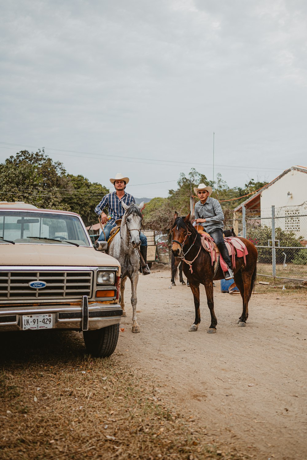 a couple of men riding on the backs of horses