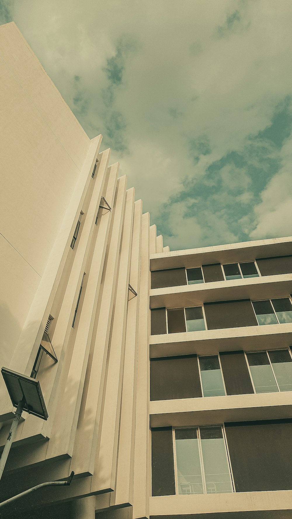 a tall building with a street sign in front of it