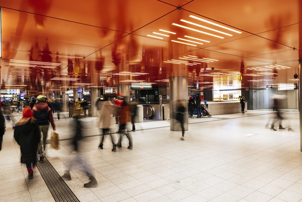 a blurry photo of people walking through a train station