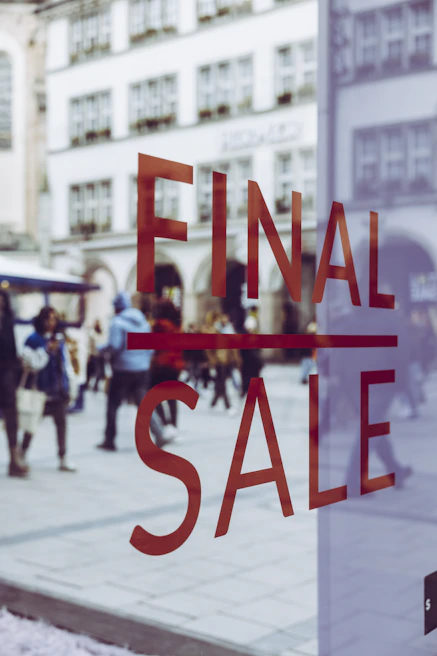 a glass window with a sale sign in it