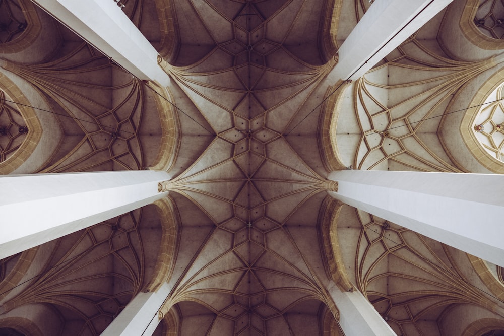 the ceiling of a large building with a clock on it