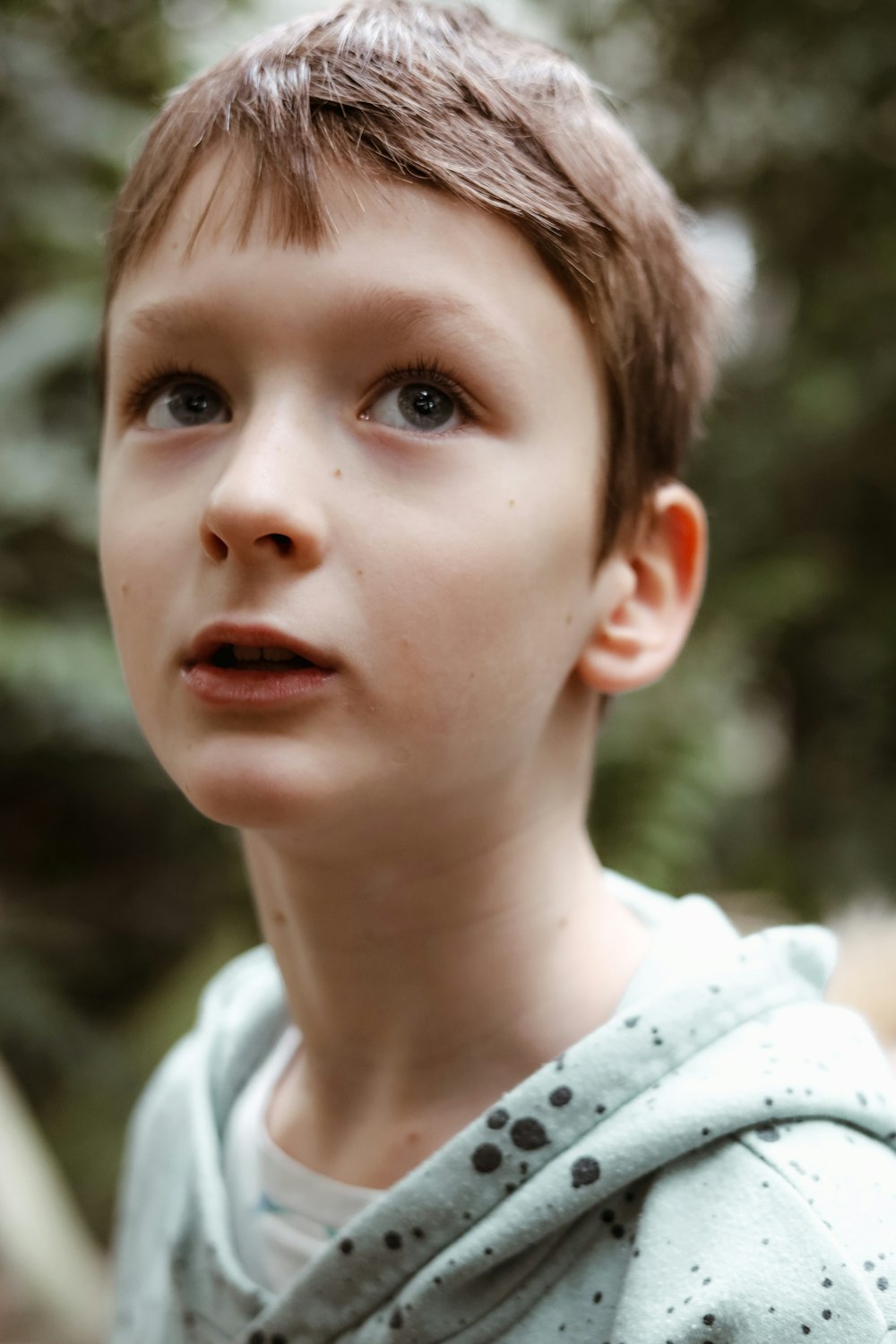 a close up of a child with a hoodie on