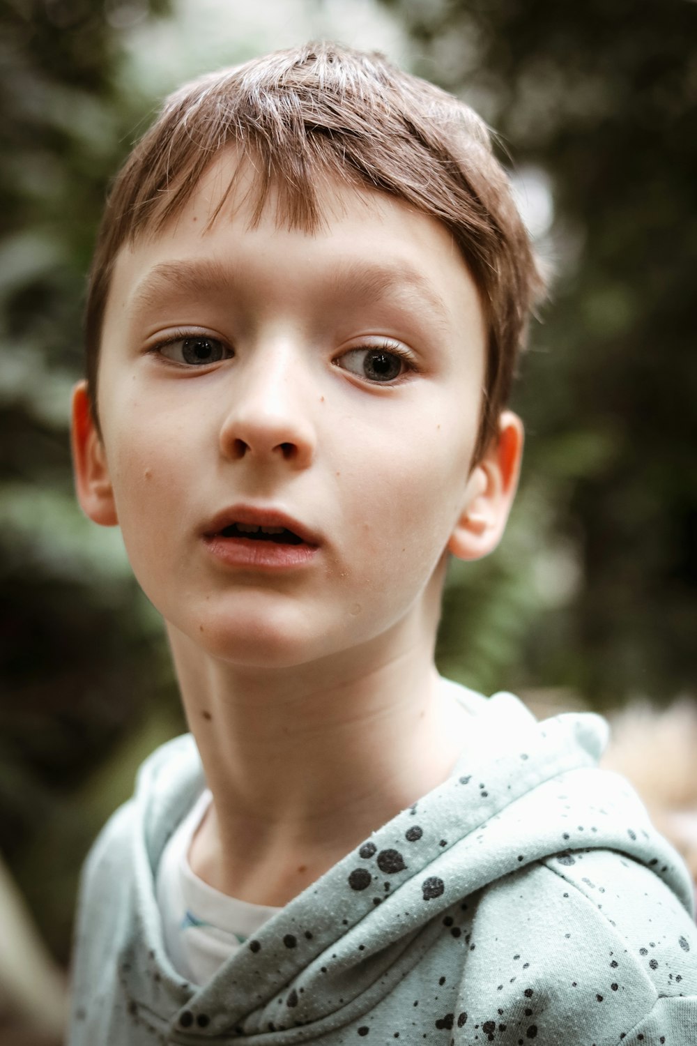 a close up of a child wearing a hoodie