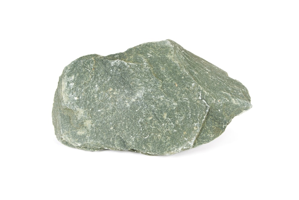 a green rock on a white background