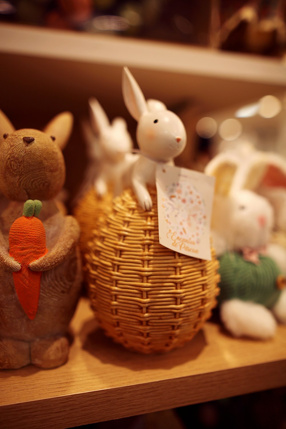 a group of stuffed animals sitting on top of a wooden shelf