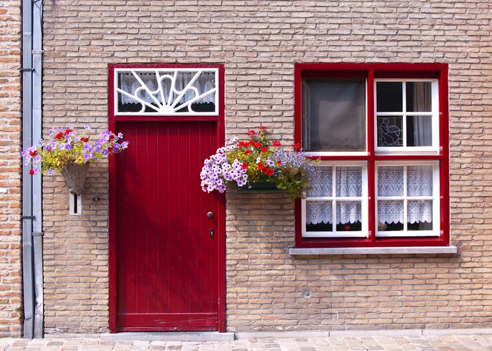 a brick building with a red door and window