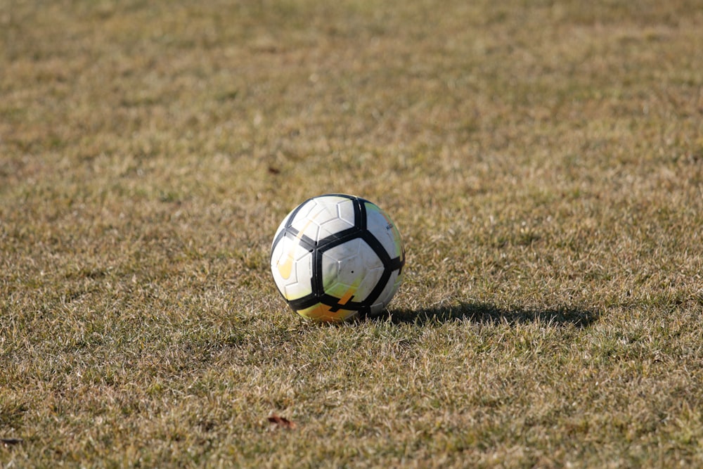 a soccer ball sitting in the middle of a field