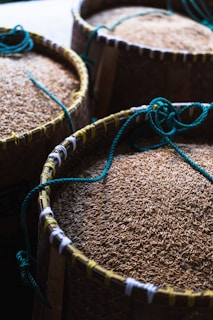 Fresh grains and pulses spilling gently from traditional woven baskets