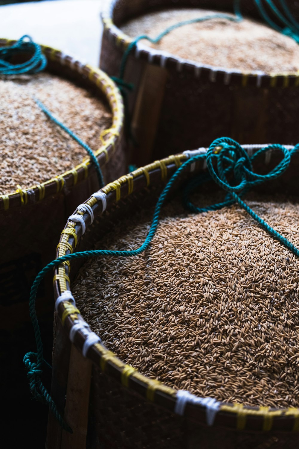 a close up of three baskets filled with rice