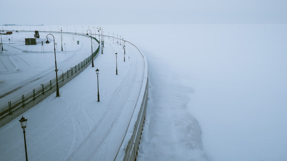 a snowy road with street lights and street lamps